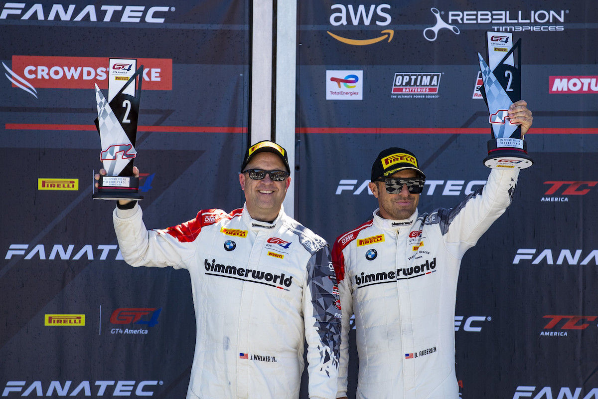 Walker and Auberlen on the podium holding trophies at Watkins Glen 2021