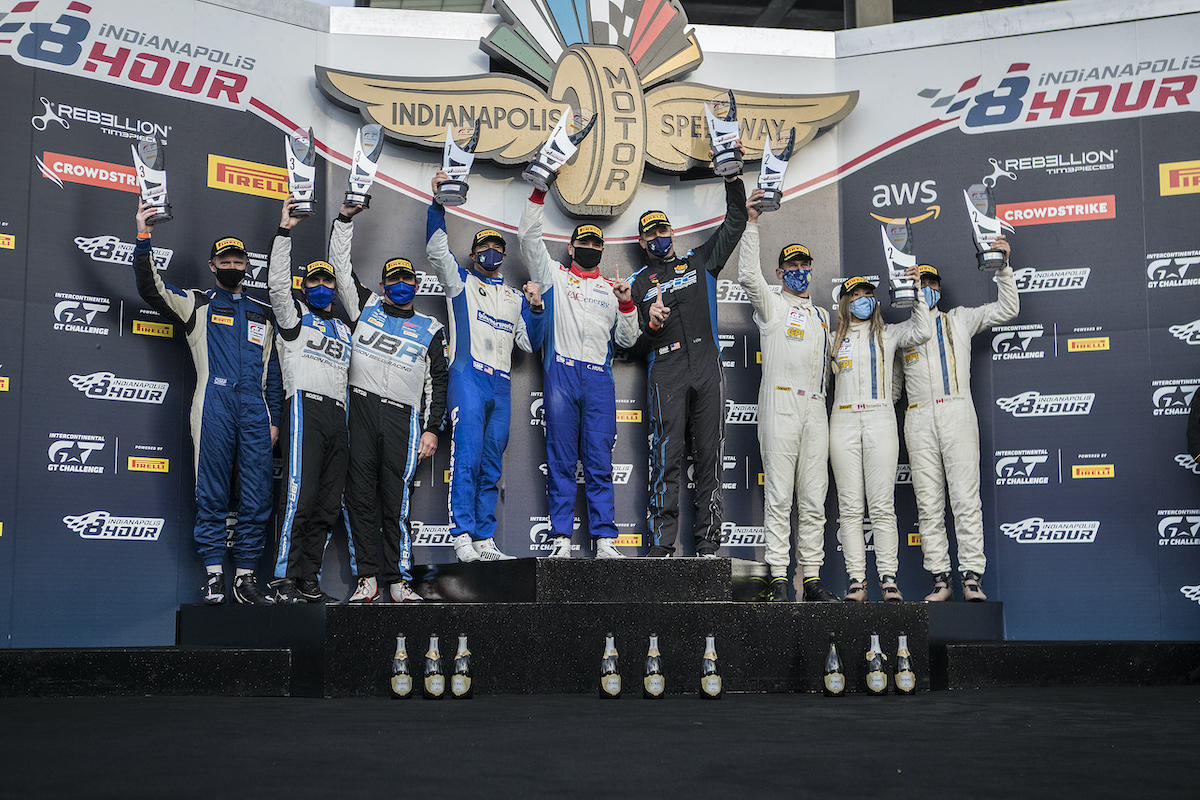 Bill Auberlen, James Clay, and James Walker, Jr. on the podium after winning the 8-hour endurance race at Indy