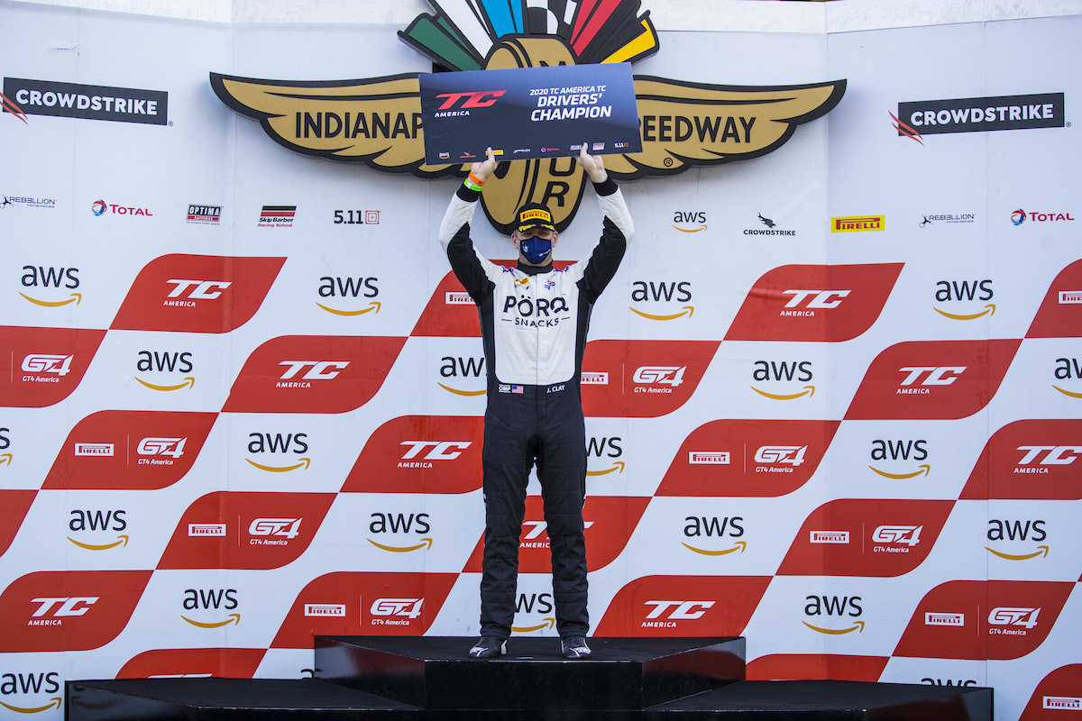 James Clay holding Driver's Champion sign at Indy