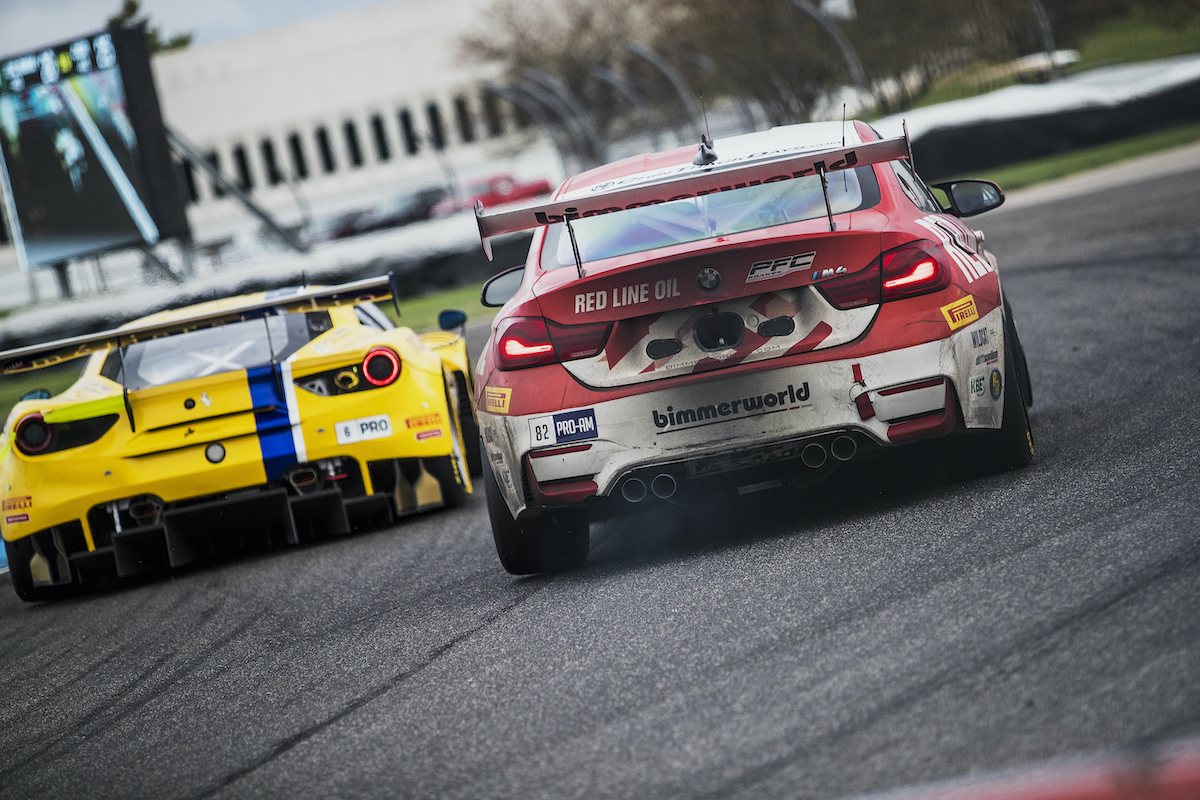 BimmerWorld Red Line Oil BMW M4 GT4 chasing a Ferrari at Indy