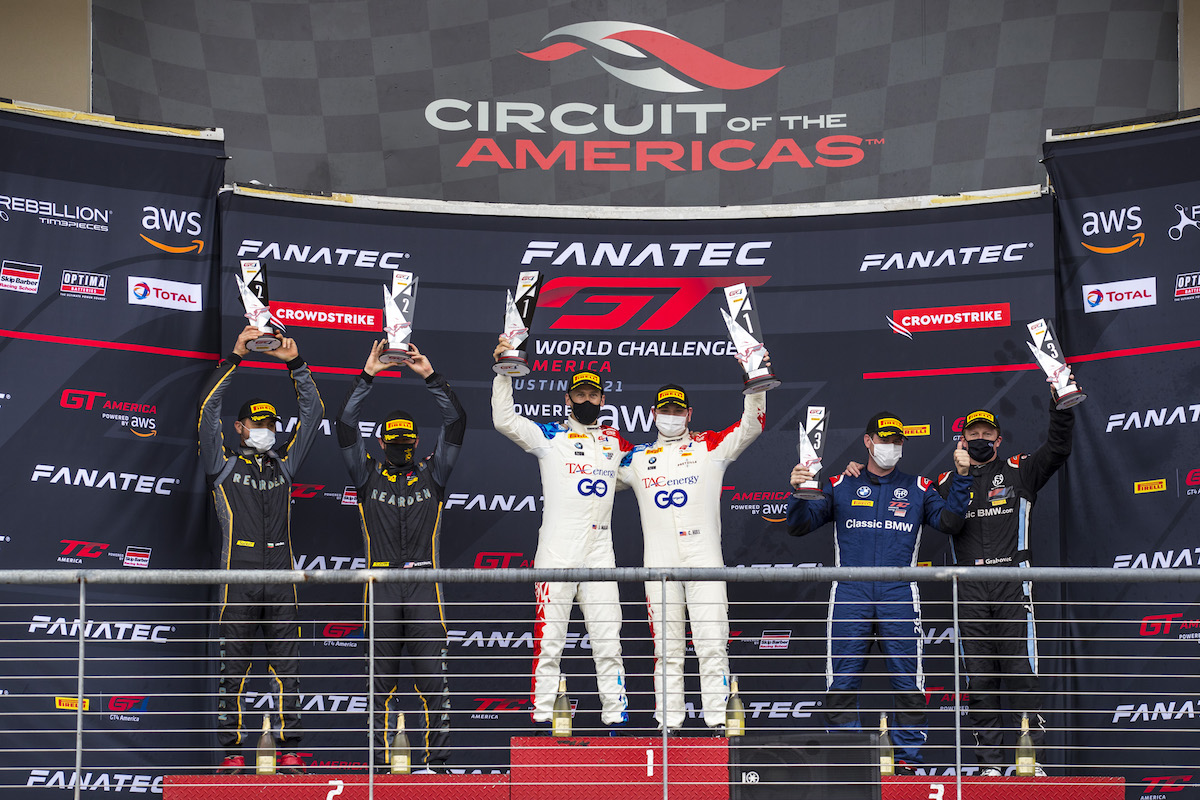 BimmerWorld drivers Chandler Hull and Jon Miller celebrating their win on the top step of the podium at COTA