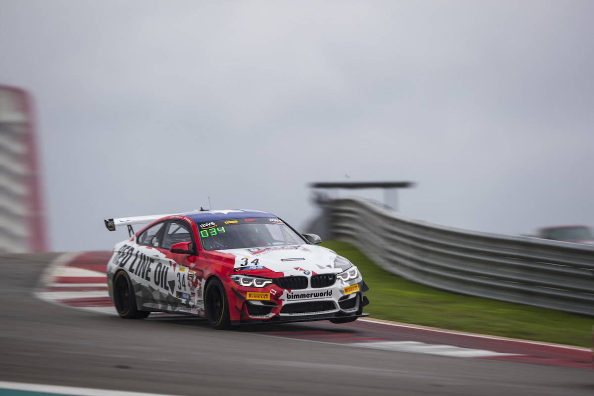 No. 34 BimmerWorld Red Line Oils M4 GT4 mid-corner on three wheels