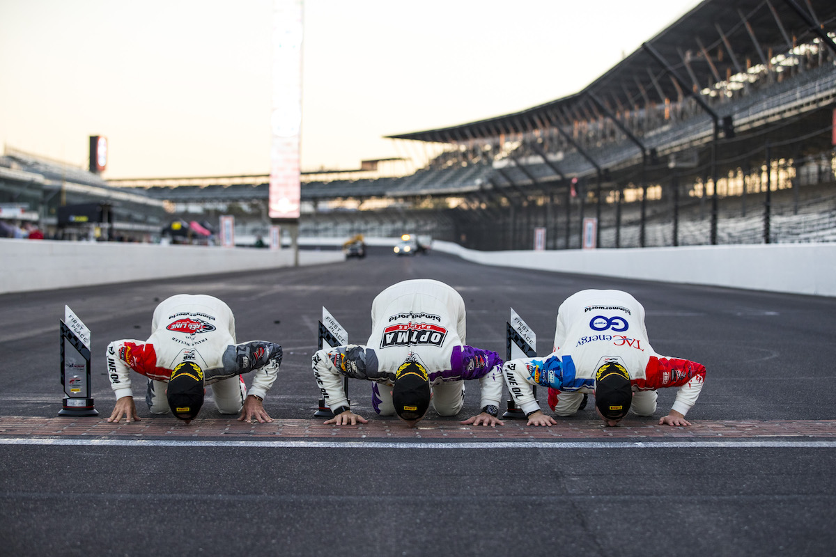 BimmerWorld drivers kissing the bricks at Indy 2021