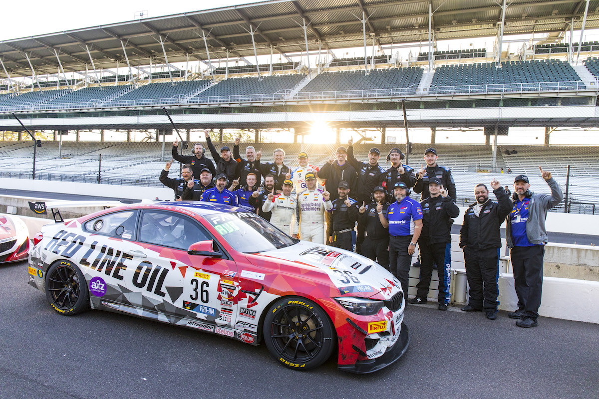 BimmerWorld team celebrating win behind M4 GT4 at Indy 2021