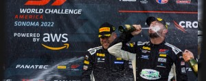 Clay and Postins celebrating with champagne on the podium at Sonoma